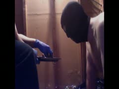 A guy in a mask consuming feces on a plate